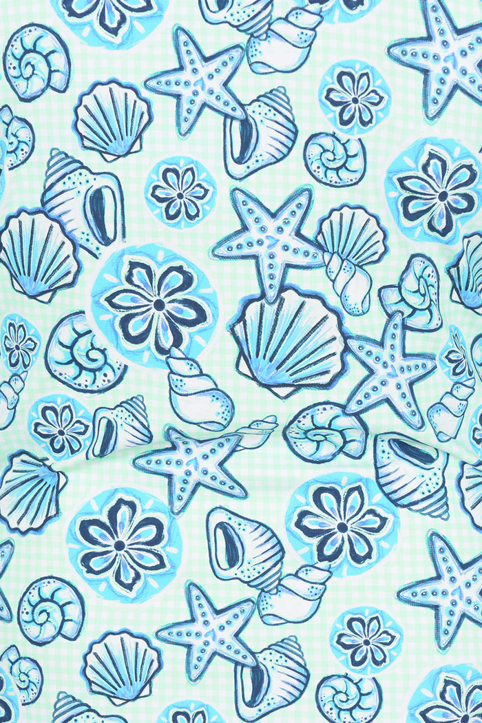 Pattern of blue seashells and starfish on a light blue background.