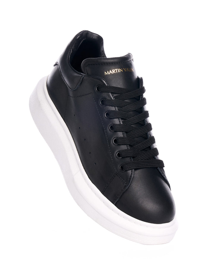 Martin Valen Hype Sole black leather sneakers, angled close-up of the front and lacing with visible white chunky sole