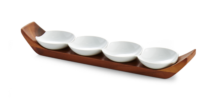 Four white porcelain snack bowls arranged on a woodenAcacia wood base, isolated on a white background.