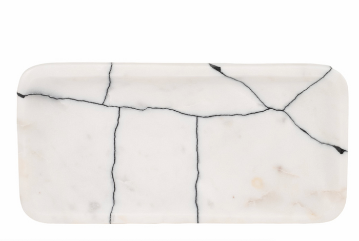 A black and white marble trinket tray with a geometric pattern.