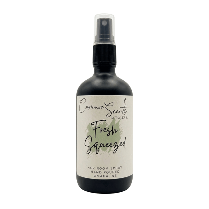 Black spray bottle with a white label reading "Fresh Squeezed," featuring a green watercolor accent, displaying the 4oz Luxury Room Spray | CommonScents by Tayler E brand.