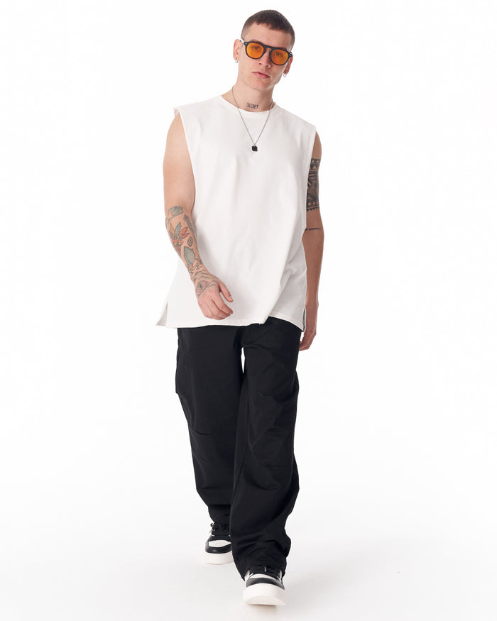 Martin Valen black wide-leg trousers with adjustable cuff, full rear leg view showing hem and sneakers