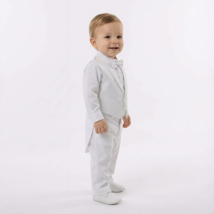 Child wearing a white suit with a bow tie on a white background