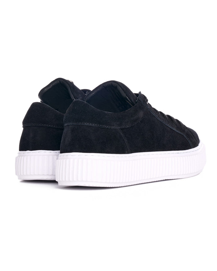 Pair of Martin Valen black genuine leather casual sneakers, three-quarter angle highlighting white platform sole and rounded toe