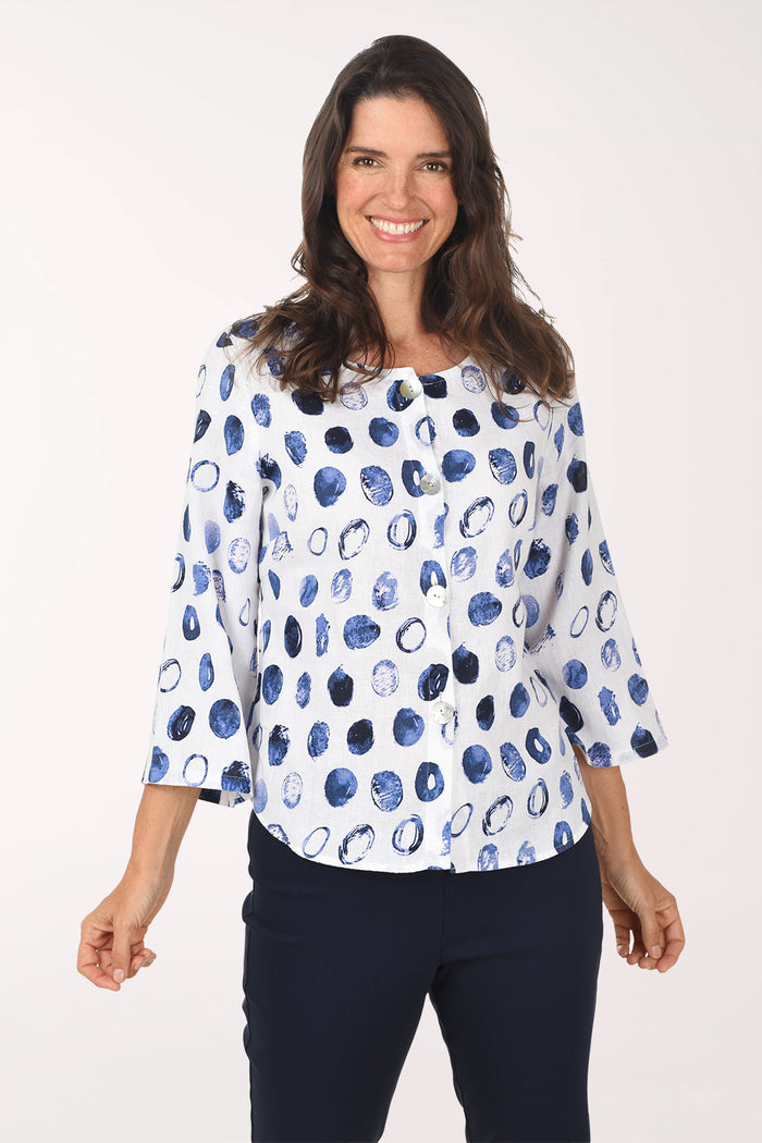 Woman wearing a white blouse with blue abstract pattern on a white background