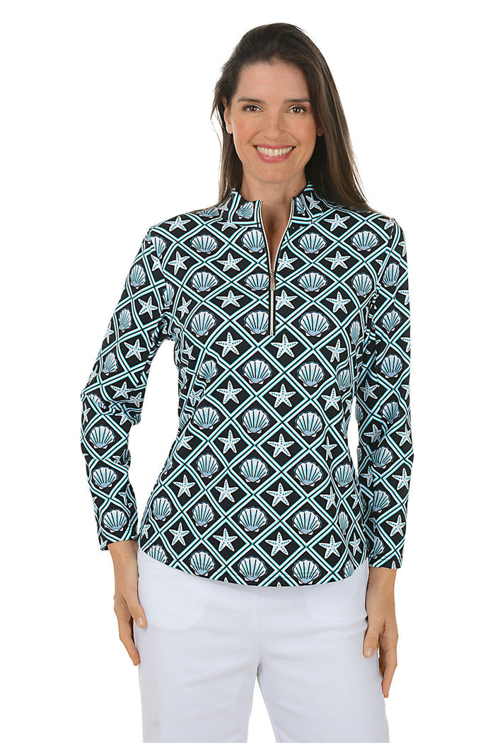 Woman wearing a patterned long-sleeve shirt with a white background.