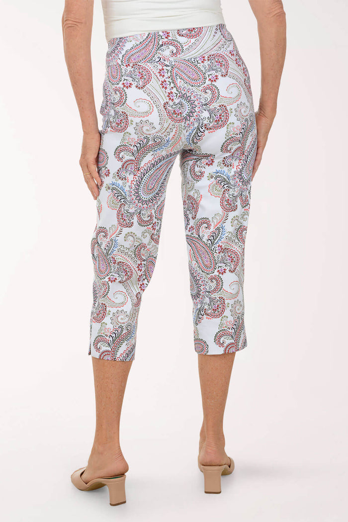 Person wearing a patterned capri pants on a white background