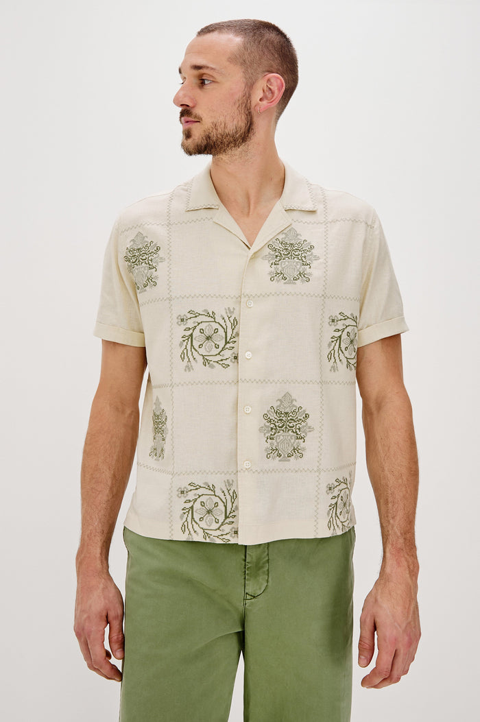 Clairo Button Front Shirt with a Relaxed Lapel, Cuffed Short Sleeves and Embroidery throughout in Cream Quilt Squares Colorway. Front View Shown on Model.
