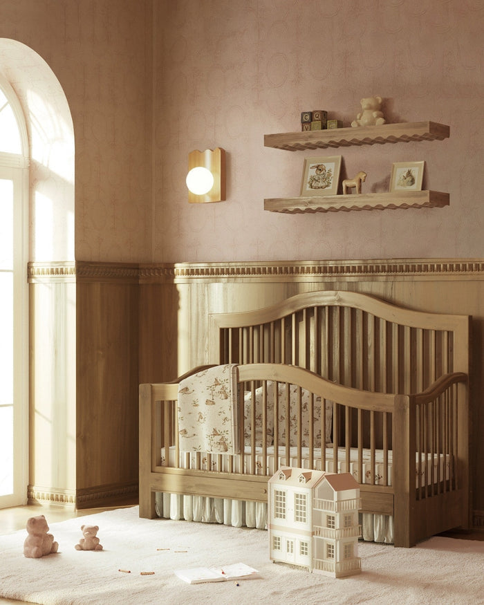 Nursery interior featuring an oak wood wall sconce with a round white glass globe mounted above a wooden crib.