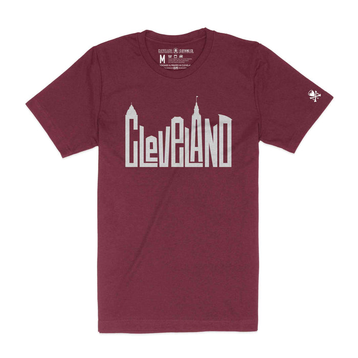 A maroon and gold unisex crew t-shirt with the word 'CLEVELAND' printed in white, featuring the city's skyline.
