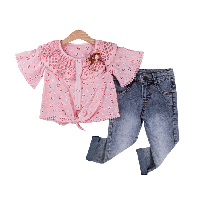 Pink eyelet lace top with buttons and bow detail paired with rolled-hem faded blue jeans for girls.