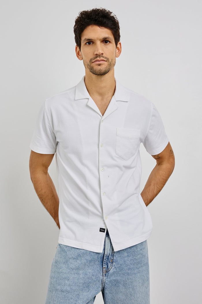 Flint Collared Button Shirt with Short Sleeves and a Chest Pocket in White Colorway. Front View Shown on Model.