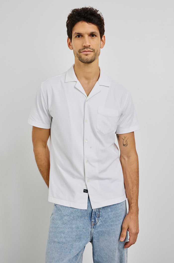 Flint Collared Button Shirt with Short Sleeves and a Chest Pocket in White Colorway. Front View Shown on Model.