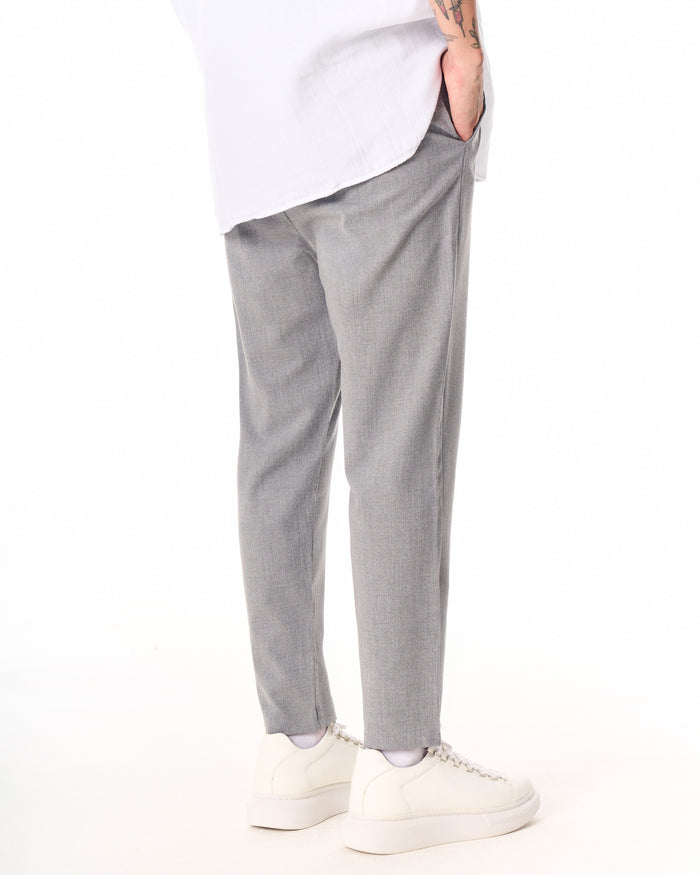 Martin Valen gray casual slim-fit trousers, rear mid-thigh view with hand in pocket and visible side seam
