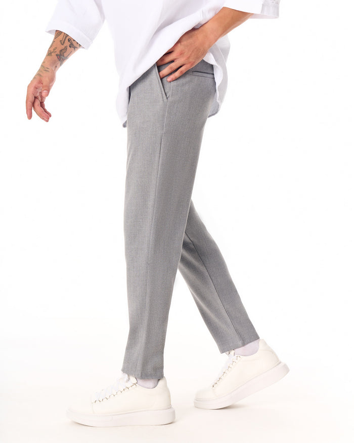 Martin Valen gray casual slim-fit trousers, full-leg view styled with white platform sneakers and cropped ankle length