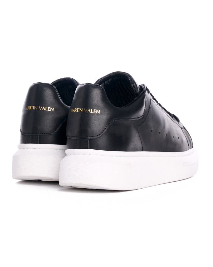 Martin Valen Hype Sole — close-up of the black sneakers' heel showing gold "Martin Valen" logo and white platform sole