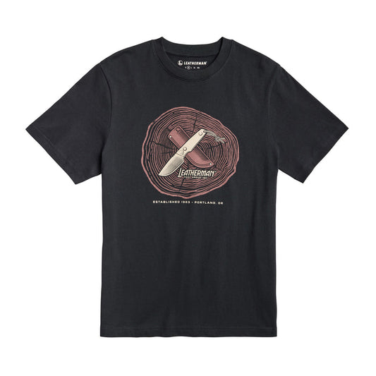 Front of the black Leatherman Blade & Grain tee  showcasing a fix blade knife and leather sheath on a stump