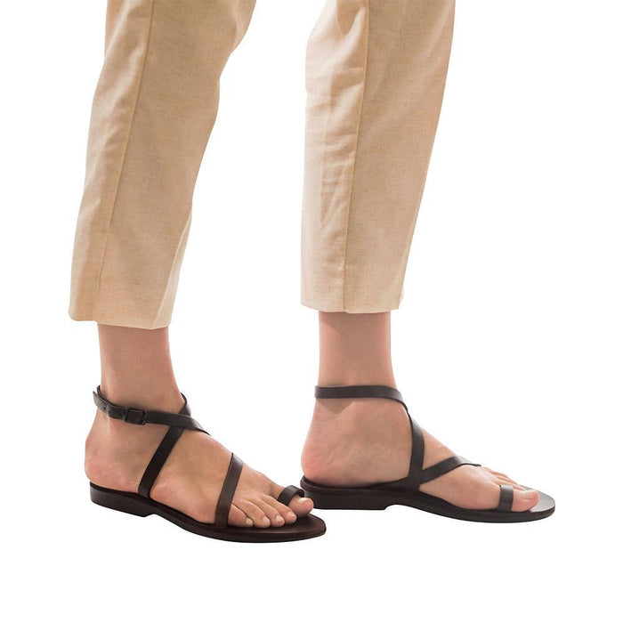 Model wearing Mara brown, handmade leather sandals with back strap and toe loop