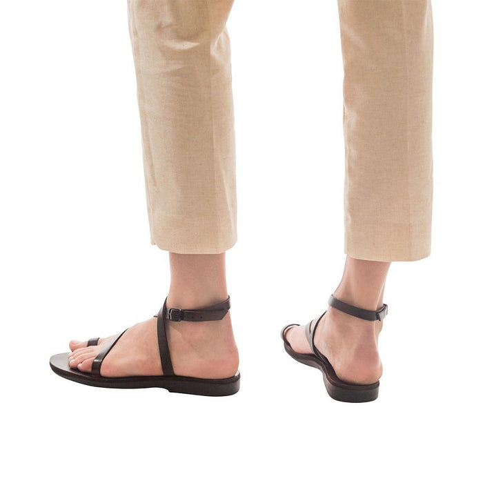 Model wearing Mara brown, handmade leather sandals with back strap and toe loop