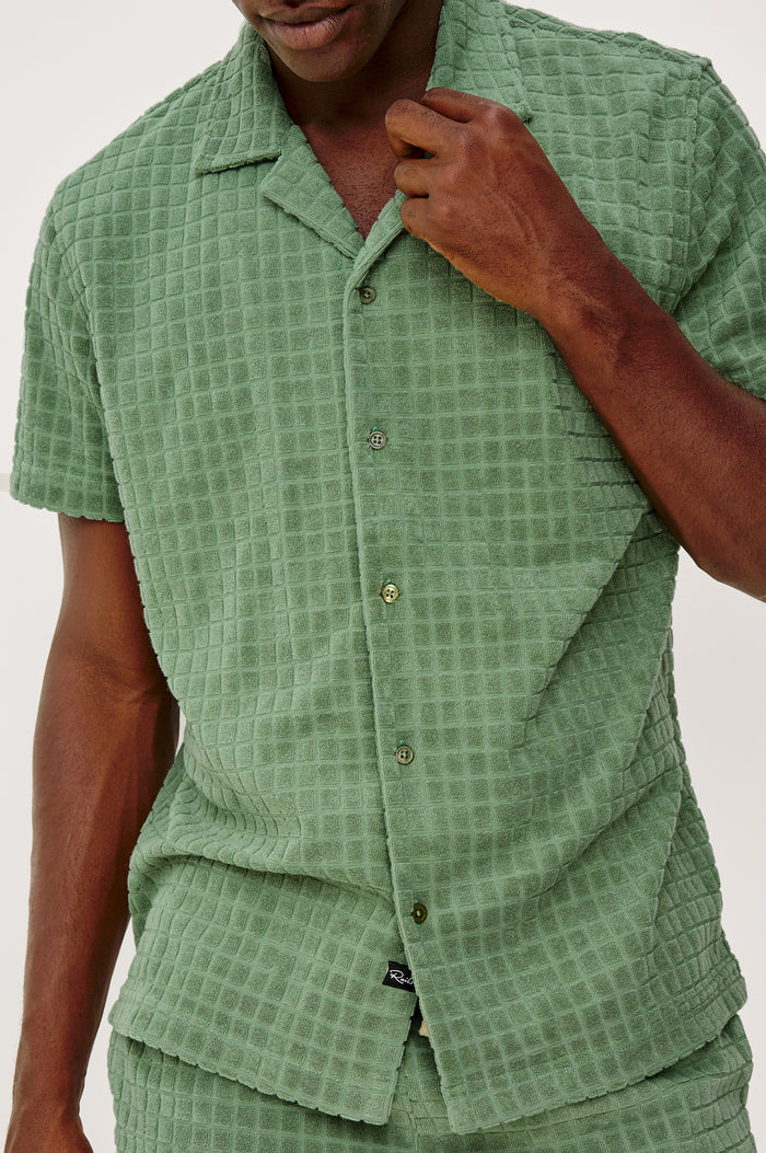 Maverick Short Sleeve Shirt in French Terry With Jacquard Pattern, Notched Collar, Front Buttons, and Classic Fit in Green Bay Grid Colorway - Upper Body Front Detail View Featured on Model