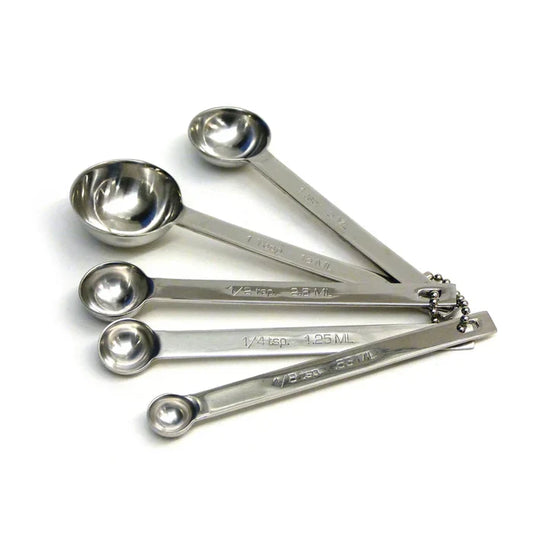 Set of stainless steel measuring spoons on a white background