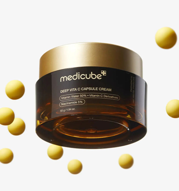 A jar of Medicube Deep Vita C Capsule Cream with capsules visible in the air, indicating the product's dual-texture.