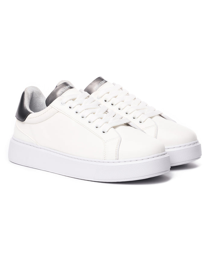 Pair of Martin Valen Iconic men's casual sneakers in white with black tongue and heel accents, angled front view