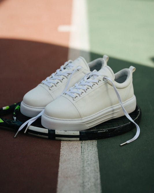 Martin Valen men's Trine white casual sneakers, three-quarter front view with untied laces and visible platform sole