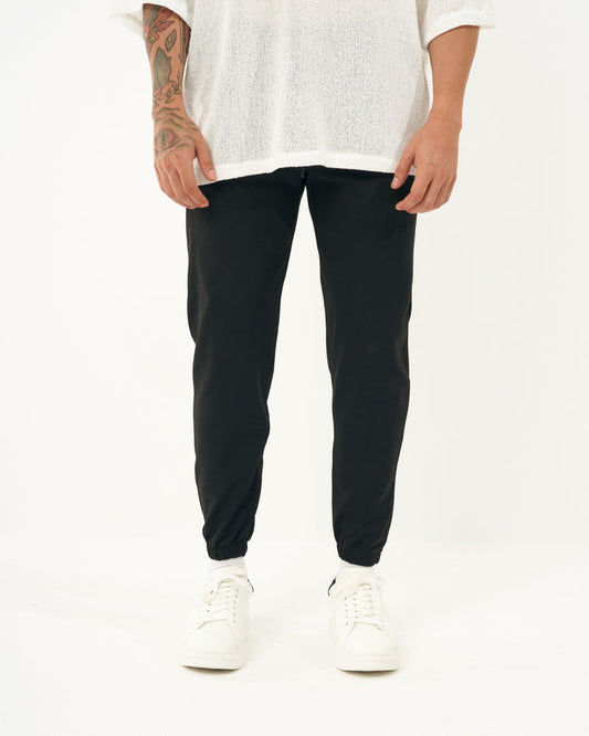 Martin Valen men's black jogger, front mid-shot showing elastic waist and cuffed ankles