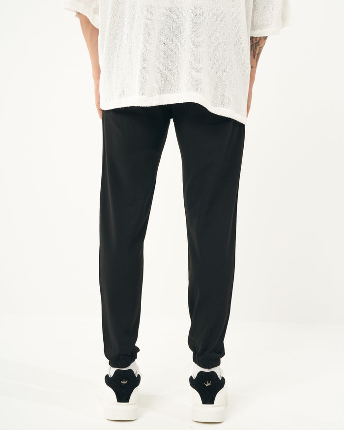 Martin Valen men's black jogger close side view showing waistband and straight leg with elastic cuff