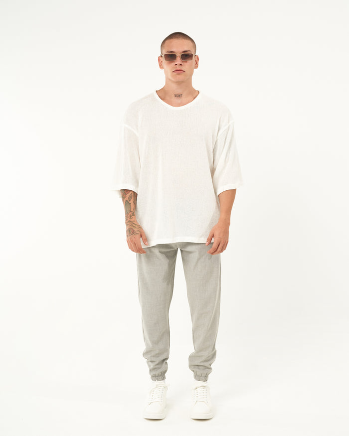 Martin Valen men's gray jogger, full-length front view with elastic cuffs and white sneakers visible