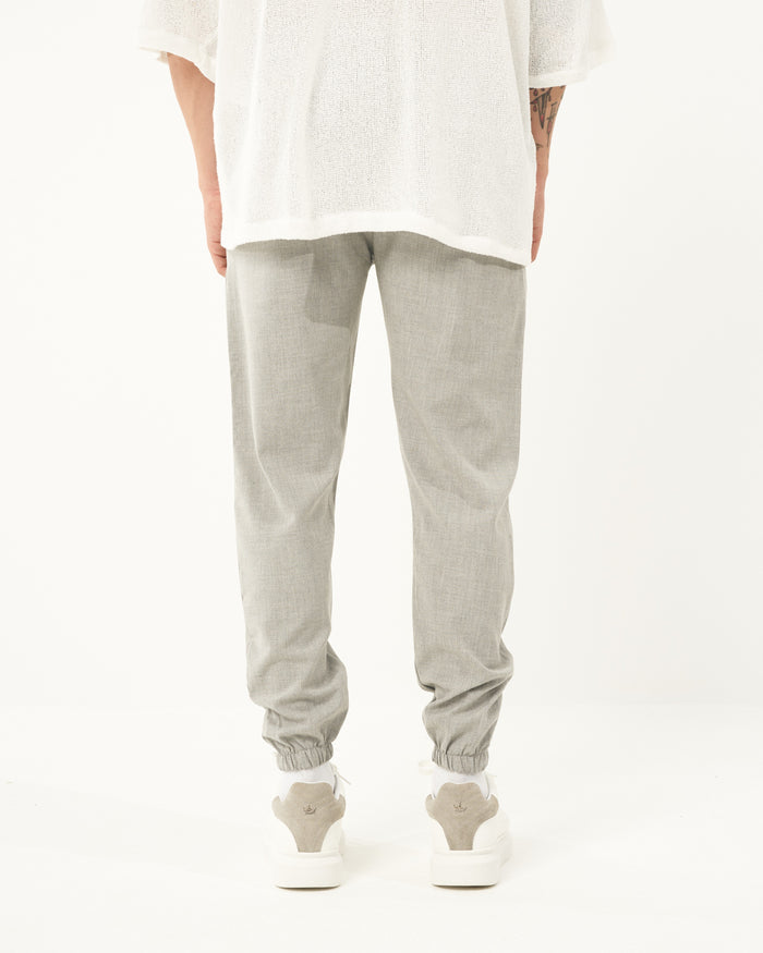 Martin Valen men's gray jogger, full front view showing loose fit, elastic cuffs and white top visible