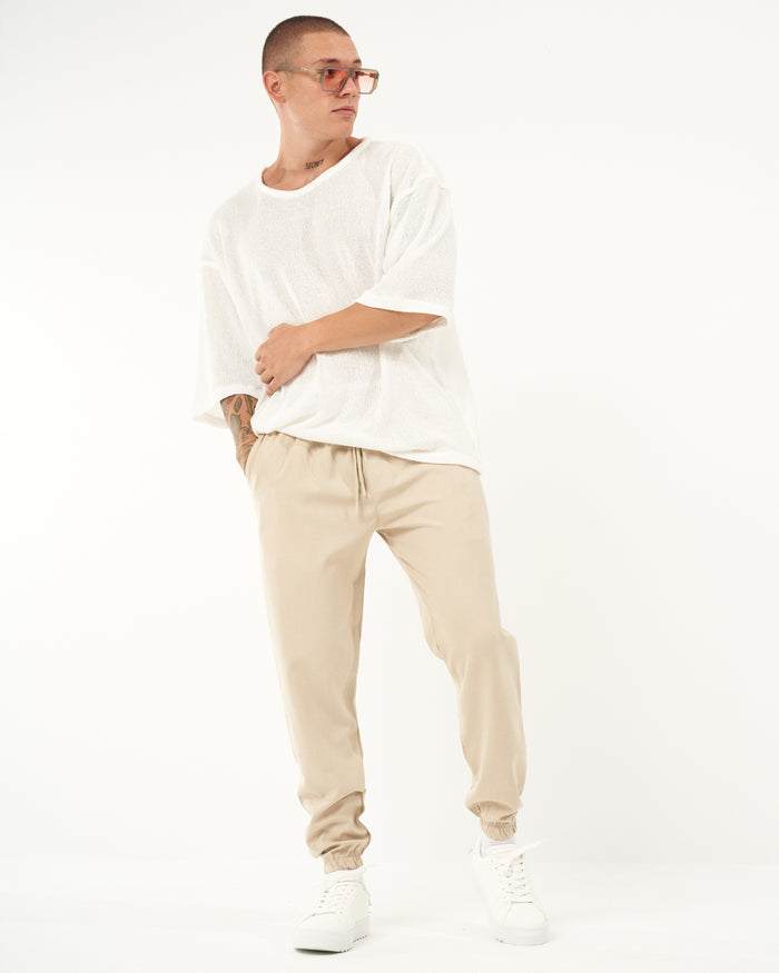 Martin Valen men's loose-fit beige jogger, three-quarter front view showing elastic waistband