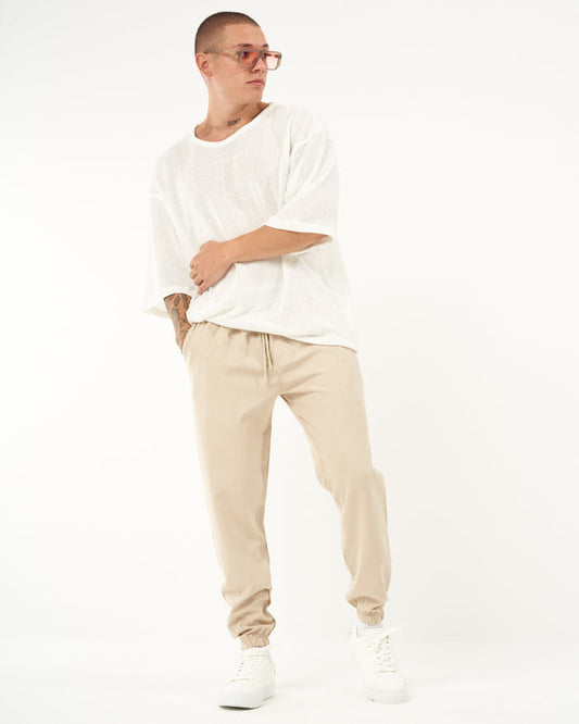 Martin Valen men's loose-fit beige jogger, three-quarter front view showing elastic waistband