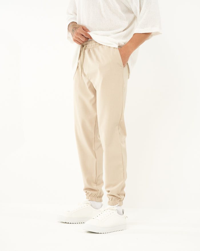 Martin Valen men's loose-fit beige jogger, side close-up showing pocket and drawstring detail