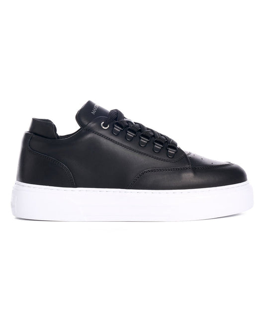 Martin Valen black low-top leather sneaker side view with visible laces and eyelets, thick white sole