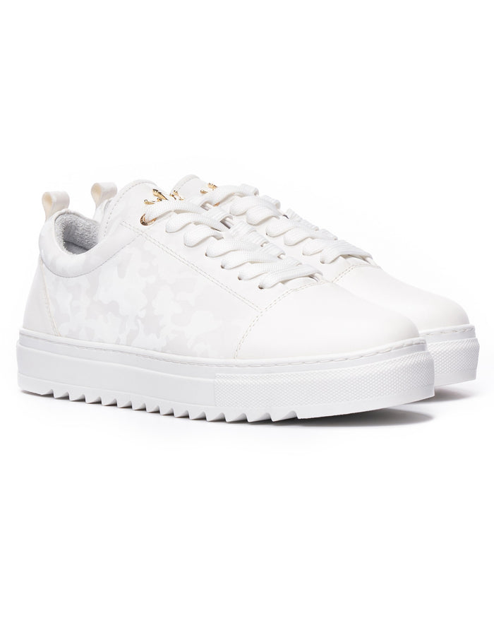Pair of Martin Valen white low-top sneakers, three-quarter front view with flat laces and gold eyelets
