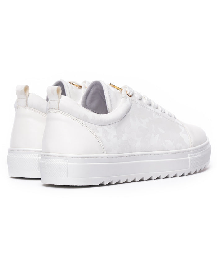 Martin Valen pair of white low-top sneakers, front three-quarter view highlighting rounded toe and thick platform sole