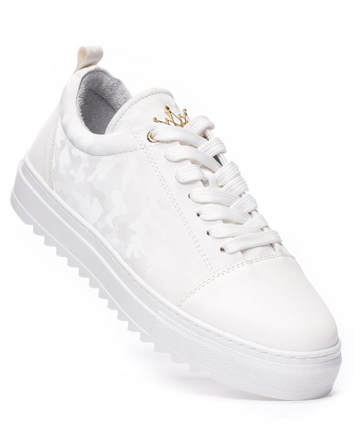 Martin Valen white low-top sneakers, angled close-up showing subtle camo pattern and gold crown charm on the tongue