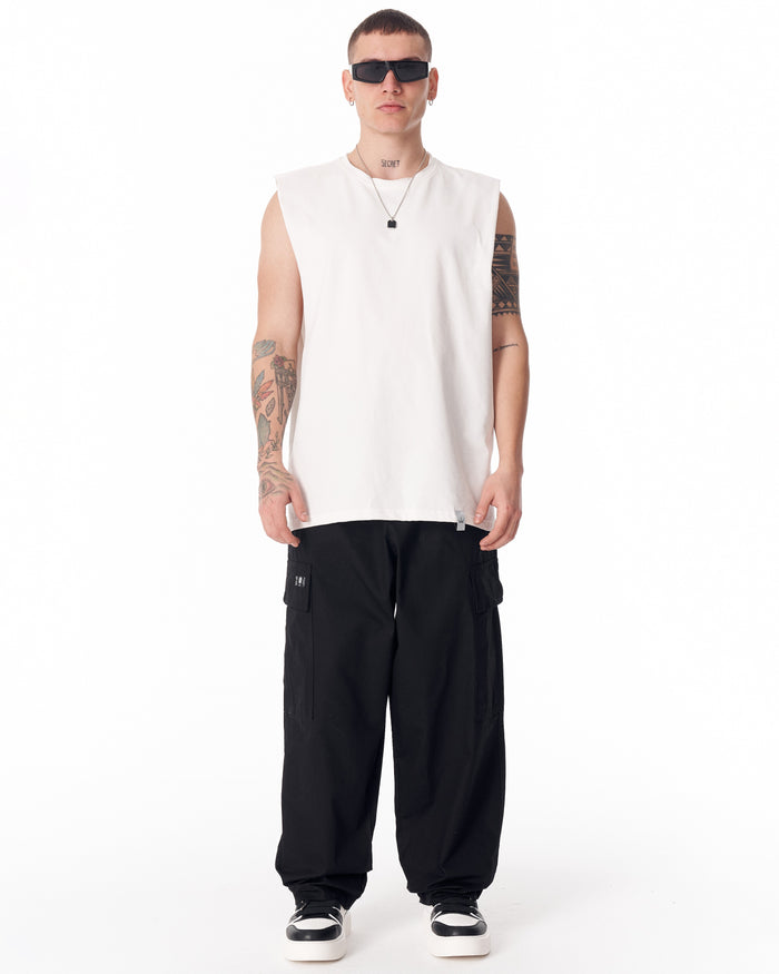 Martin Valen men's black cargo pants full-length view showing relaxed silhouette and gathered hems over sneakers