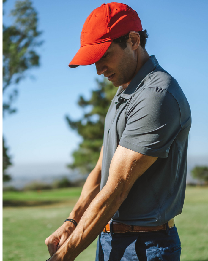 Man playing golf wearing short sleeve polo shirt in smoke (Style 11004) - BloqUV