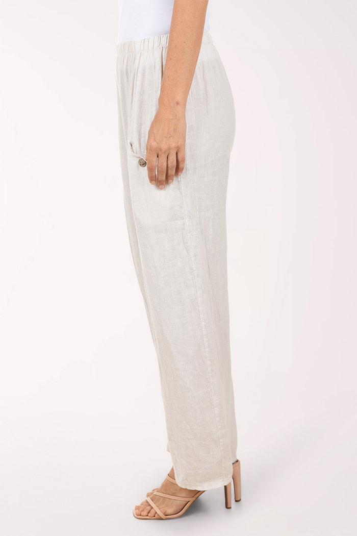 Beige wide-leg pants worn by a person on a white background