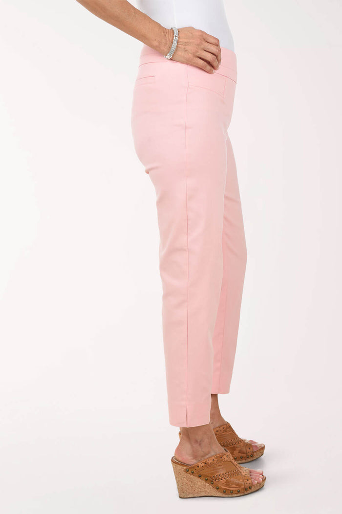 Person wearing light pink pants on a white background - side shot