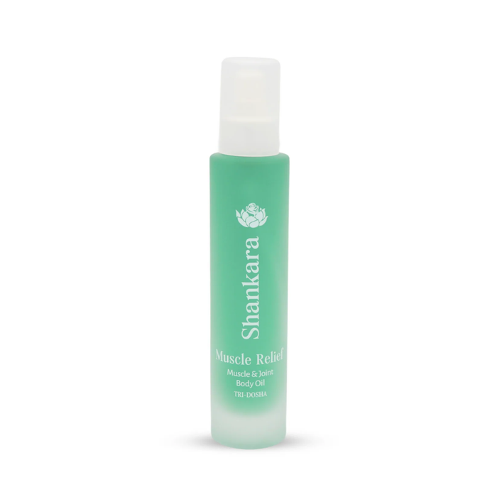 A green frosted glass bottle of Muscle Relief Oil | Shankara, designed for muscle and joint body care, featuring a white spray cap and minimalist text branding.