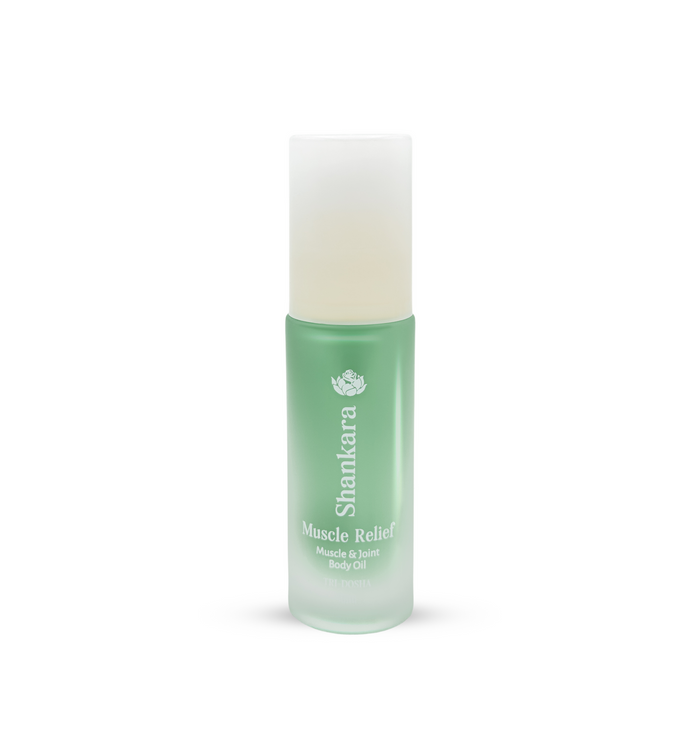 Green frosted glass bottle of Muscle Relief Oil | Shankara with a white cap, designed for muscle and joint body care and wellness.