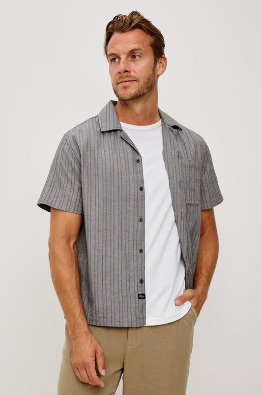 Ohana Button-Up Shirt in Textured Shirting WIth Short Sleeves, Collar, and Relaxed Fit in Charcoal Chambray Colorway - Upper Body Front View Featured on Model
