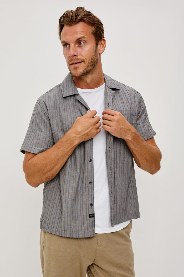 Ohana Button-Up Shirt in Textured Shirting WIth Short Sleeves, Collar, and Relaxed Fit in Charcoal Chambray Colorway - Upper Body Front View Featured on Model