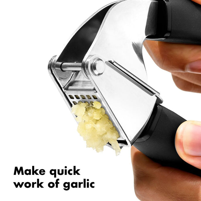 Garlic press with minced garlic and text 'Make quick work of garlic' on a white background