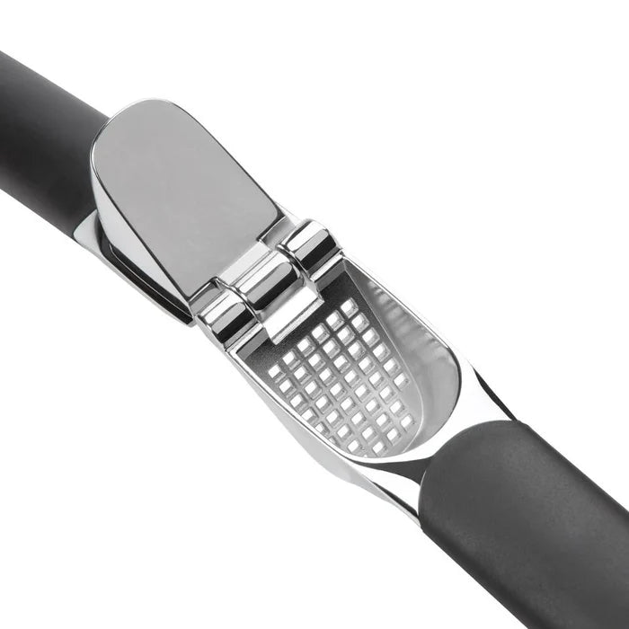 Garlic press with black handle and silver metal head on a white background