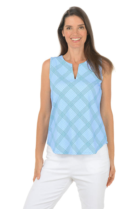 Woman wearing a light blue checkered sleeveless top and white pants on a white background.